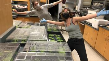Anna and Celine open arms in the lab at the end of a long day of experiment